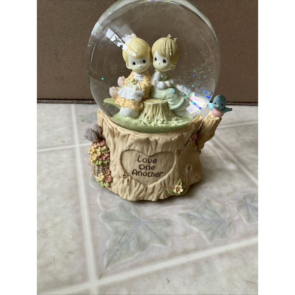 Love One Another Water Globe Plays "Love Will Keep Us Together" sitting on stump